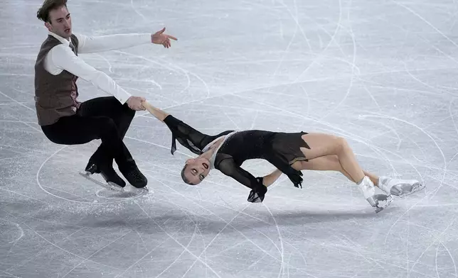 Anastasiia Metelkina and Luka Berulava, of Georgia, compete in the pairs's free skating segment at the ISU Grand Prix Finals of Figure Skating, Friday, Dec. 6, 2024, in Grenoble, France. (AP Photo/Laurent Cipriani)