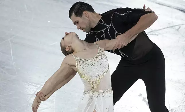 Minerva Fabienne Hase and Nikita Volodin, of Germany, compete in the pairs's free skating segment at the ISU Grand Prix Finals of Figure Skating, Friday, Dec. 6, 2024, in Grenoble, France. (AP Photo/Laurent Cipriani)