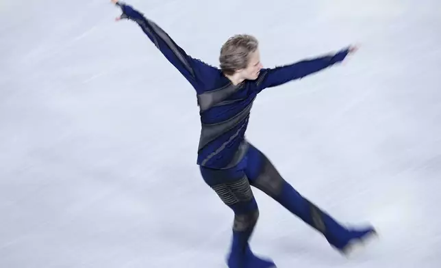 Ilia Malinin, of the United States, competes in the men's short program segment at the ISU Grand Prix Finals of Figure Skating, Friday, Dec. 6, 2024, in Grenoble, France. (AP Photo/Laurent Cipriani)