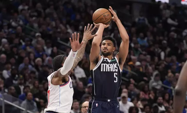 Dallas Mavericks guard Quentin Grimes (5) shoots against Los Angeles Clippers guard Kevin Porter Jr. (77) during the second half of an NBA basketball game Saturday, Dec. 21, 2024, in Dallas. (AP Photo/LM Otero)