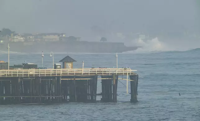 Damage is seen on the end of Santa Cruz Wharf during high surf in Santa Cruz, Calif., Monday, Dec. 23, 2024. (AP Photo/Nic Coury)