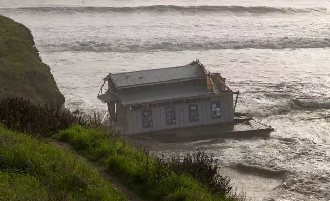 The remnants of a restaurant float at the head of the San Lorenzo River in Santa Cruz, Calif., Monday, Dec. 23, 2024. (AP Photo/Nic Coury)