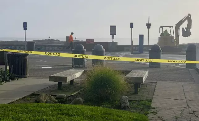 Caution tape closes Capitola Beach due to high surf on Monday, Dec. 23, 2024, in Capitola, Calif. (AP Photo/Pamela Hassell)