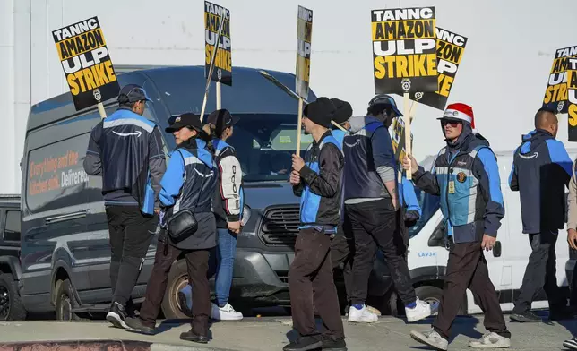 Amazon workers strike outside the gates of an Amazon Fulfillment Center as Teamsters seek labor contract nationwide Thursday, Dec. 19, 2024, in City of Industry, Calif. (AP Photo/Damian Dovarganes)