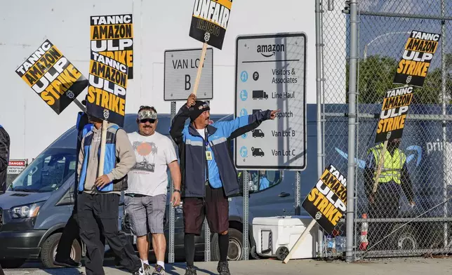 Amazon workers, on strike, picket outside an Amazon Fulfillment Center, Thursday, Dec. 19, 2024, in City of Industry, Calif. (AP Photo/Damian Dovarganes)