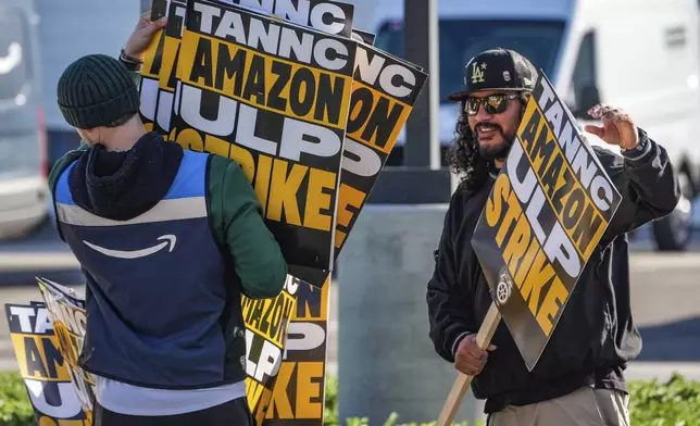 Amazon workers strike outside the gates of an Amazon Fulfillment Center as Teamsters seek labor contract nationwide, Thursday, Dec. 19, 2024, in City of Industry, Calif. (AP Photo/Damian Dovarganes)