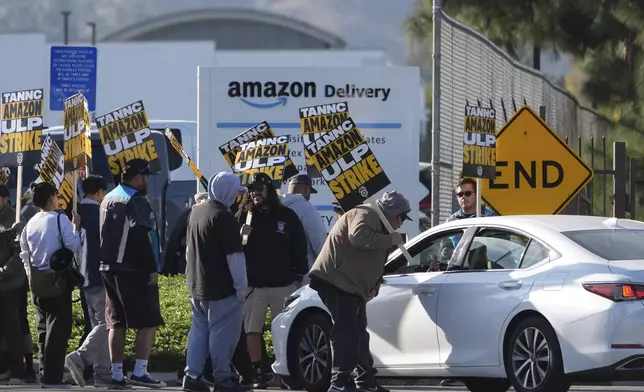 Amazon workers, on strike, picket outside an Amazon Fulfillment Center, Thursday, Dec. 19, 2024, in City of Industry, Calif. (AP Photo/Damian Dovarganes)