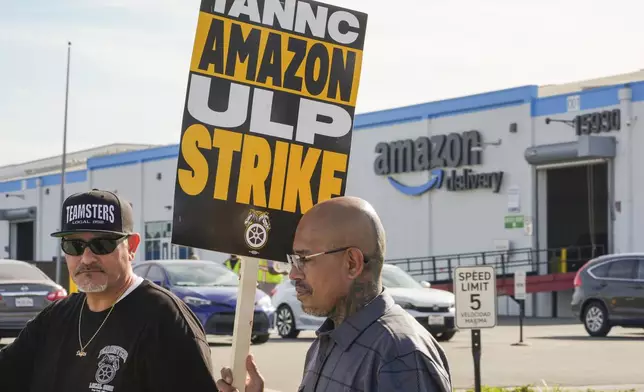 Amazon workers, on strike, picket outside an Amazon Fulfillment Center, Thursday, Dec. 19, 2024, in City of Industry, Calif. (AP Photo/Damian Dovarganes)