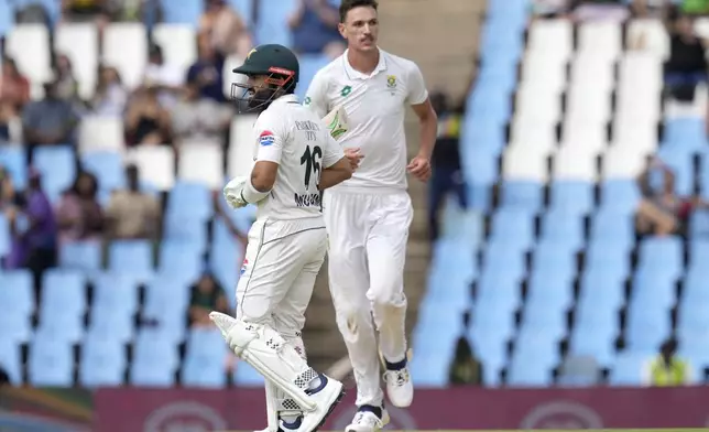 Pakistan's Mohammad Rizwan, left, leaves the crease after being dismissed by South Africa's Marco Jansen, for 3 runs during day three of the Test cricket match between South Africa and Pakistan, at the Centurion Park in Centurion, South Africa, Saturday, Dec. 28, 2024. (AP Photo/Themba Hadebe)