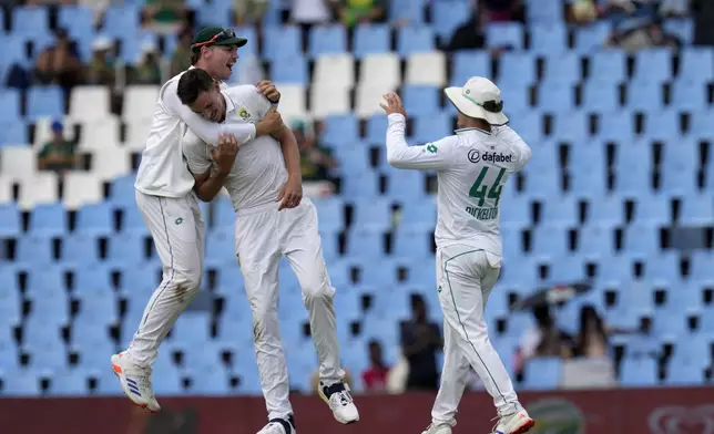 South Africa's Marco Jansen, center, celebrates with his teammates after dismissing Pakistan's Babar Azam for 50 runs during day three of the Test cricket match between South Africa and Pakistan, at the Centurion Park in Centurion, South Africa, Saturday, Dec. 28, 2024. (AP Photo/Themba Hadebe)