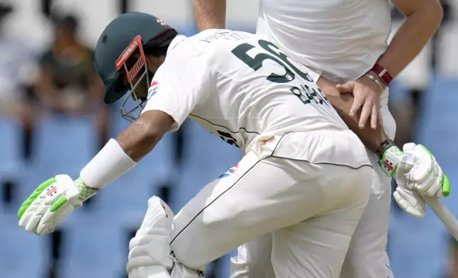 South Africa's Corbin Bosch, right, collides with Pakistan's Babar Azam, left, during day three of the Test cricket match between South Africa and Pakistan, at the Centurion Park in Centurion, South Africa, Saturday, Dec. 28, 2024. (AP Photo/Themba Hadebe)