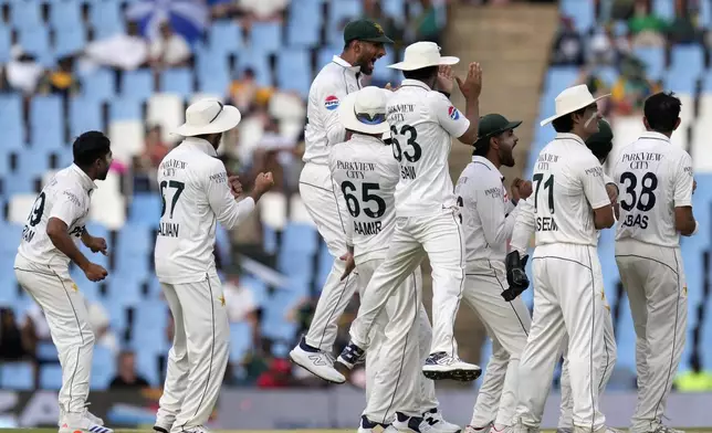 Pakistan's Khurram Shahzad, left, and his teammates celebrate a wicket of South Africa's Ryan Rickelton during day three of the Test cricket match between South Africa and Pakistan, at the Centurion Park in Centurion, South Africa, Saturday, Dec. 28, 2024. (AP Photo/Themba Hadebe)