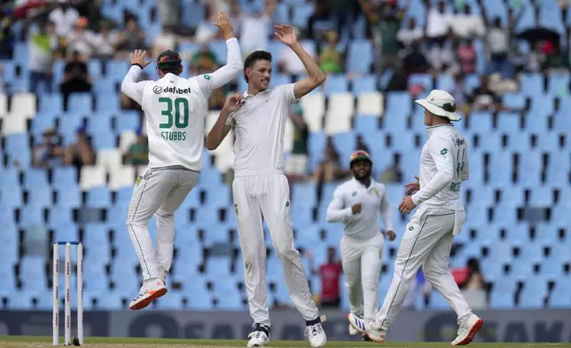 South Africa's Marco Jansen, center, celebrates with his teammates after dismissing Pakistan's Salman Agha for 1 run during day three of the Test cricket match between South Africa and Pakistan, at the Centurion Park in Centurion, South Africa, Saturday, Dec. 28, 2024. (AP Photo/Themba Hadebe)