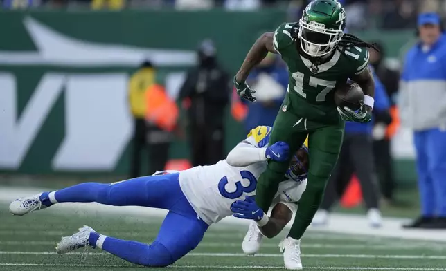 New York Jets wide receiver Davante Adams (17) runs against Los Angeles Rams safety Jaylen McCollough during the first half of an NFL football game in East Rutherford, N.J., Sunday, Dec. 22, 2024. (AP Photo/Julia Demaree Nikhinson)