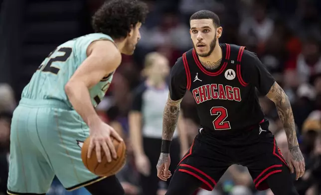 Chicago Bulls guard Lonzo Ball (2) defends against Charlotte Hornets guard Vasilije Micic during the first half of an NBA basketball game in Charlotte, N.C., Monday, Dec. 30, 2024. (AP Photo/Jacob Kupferman)