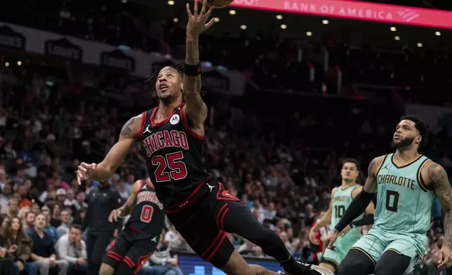 Chicago Bulls forward Dalen Terry (25) drives to the basket during the first half of an NBA basketball game against the Charlotte Hornets in Charlotte, N.C., Monday, Dec. 30, 2024. (AP Photo/Jacob Kupferman)