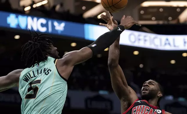Charlotte Hornets center Mark Williams (5) blocks a shot by Chicago Bulls forward Patrick Williams (44) during the first half of an NBA basketball game in Charlotte, N.C., Monday, Dec. 30, 2024. (AP Photo/Jacob Kupferman)