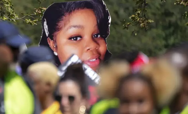 FILE - An image of Breonna Taylor, a 26-year-old Black woman who was fatally shot by police in her Louisville, Ky., apartment, is seen as people march to honor the 60th Anniversary of the March on Washington, Saturday, Aug. 26, 2023, in Washington. (AP Photo/Jacquelyn Martin, File)