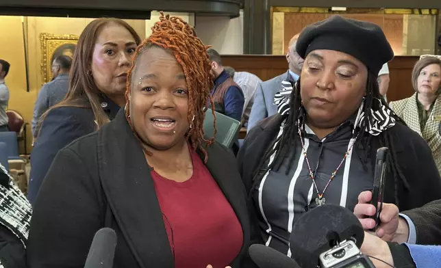 Breonna Taylor's mother, Tamika Palmer, left, discusses the consent decree the U.S. Justice Department reached with the city of Louisville, Ky., on Thursday, Dec. 12, 2024. (AP Photo/Dylan Lovan)