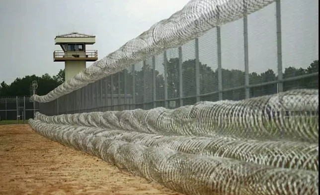 FILE - Razor wire lines a fence at Easterling Correctional Facility, August 8, 1996. (AP Photo/The Dothan Eagle, File)