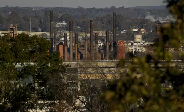 Smokestacks from the Sloss Furnaces National Historic Landmark rise above the surrounding neighborhood, Friday, Dec. 6, 2024, in Birmingham, Ala. The Sloss Furnaces once engaged in the use of convict leasing during the early 20th century. (AP Photo/Carolyn Kaster)