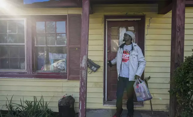 Tyrone Heard closes the door behind him as he leaves his home, Friday, Dec. 6, 2024, in Alexander City, Ala. (AP Photo/Carolyn Kaster)