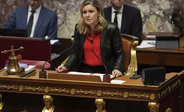 National Assembly president Yaël Braun-Pivet announces the results after France's far-right and left-wing lawmakers joined together to vote a no-confidence motion prompted by budget disputes that forces Prime Minister Michel Barnier to resign, Wednesday, Dec. 4, 2024 in Paris. (AP Photo/Michel Euler)