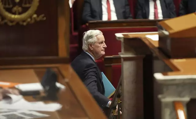 French Prime Minister Michel Barnier leaves after addressing the National Assembly prior to a vote on a no-confidence motion that could bring him down and his cabinet for the first time since 1962, Wednesday, Dec. 4, 2024 in Paris. (AP Photo/Michel Euler)