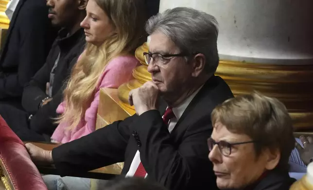 French far-left leader Jean-Luc Melenchon listens to speeches rom the tribunes at the National Assembly prior to a no-confidence vote that could bring down the Prime Minister and the government for the first time since 1962, Wednesday, Dec. 4, 2024 in Paris. (AP Photo/Michel Euler)