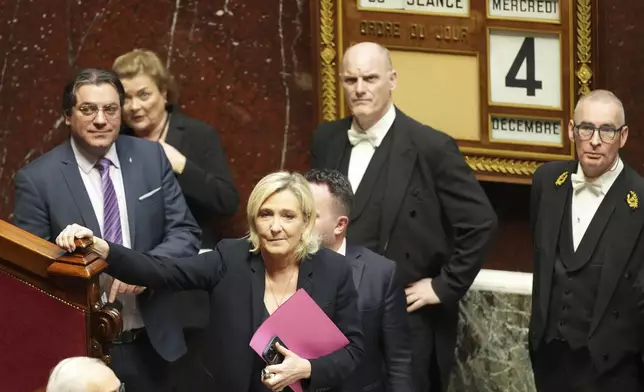 French far-right leader Marine Le Pen arrives to deliver her speech at the National Assembly prior to a no-confidence vote that could bring down the Prime Minister and the government for the first time since 1962, Wednesday, Dec. 4, 2024 in Paris. (AP Photo/Michel Euler)