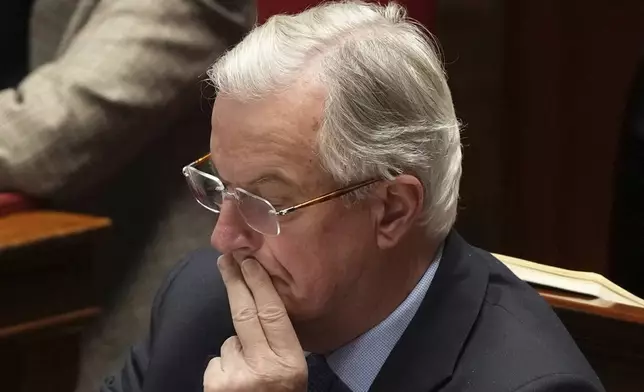 French Prime Minister Michel Barnier listens to speeches at the National Assembly prior to a no-confidence vote that could bring down the Prime Minister and the government for the first time since 1962, Wednesday, Dec. 4, 2024 in Paris. (AP Photo/Michel Euler)