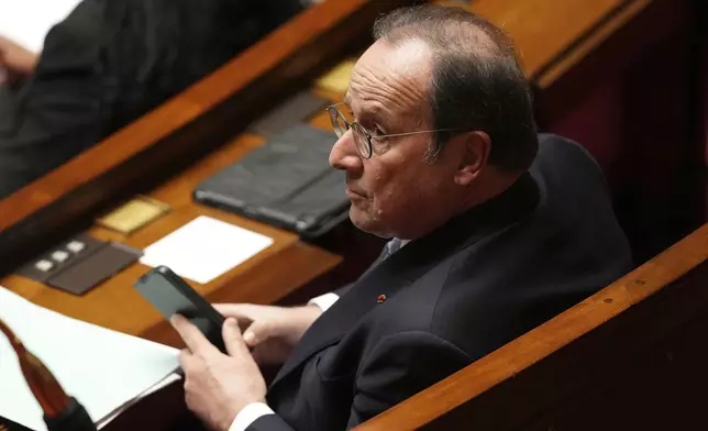 Former French President and now socialist party parliament member Francois Hollande sits at the National Assembly before French lawmakers vote on a no-confidence motion that could bring down the Prime Minister and the government for the first time since 1962, Wednesday, Dec. 4, 2024 in Paris. (AP Photo/Michel Euler)