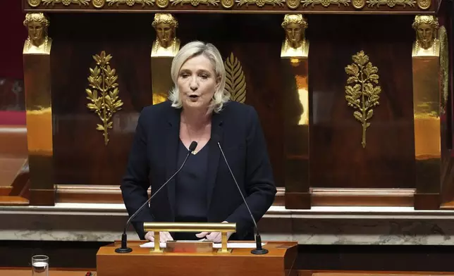 French far-right leader Marine Le Pen speaks at the National Assembly prior to a no-confidence vote that could bring down the Prime Minister and the government for the first time since 1962, Wednesday, Dec. 4, 2024 in Paris. (AP Photo/Michel Euler)