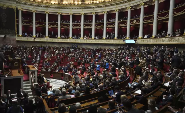 Lawmakers convene at the National Assembly during a debate and prior to a no-confidence vote that could bring down the Prime Minister and the government for the first time since 1962, Wednesday, Dec. 4, 2024 in Paris. (AP Photo/Michel Euler)