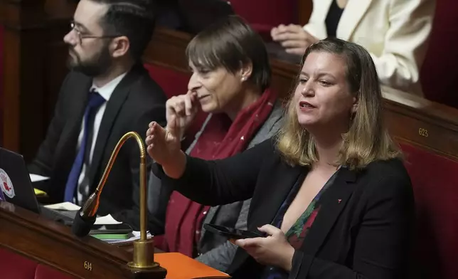 French far-left France Unbowed party parliament group president Mathilde Panot, right, gestures at the National Assembly before French lawmakers vote on a no-confidence motion that could bring down the Prime Minister and the government for the first time since 1962, Wednesday, Dec. 4, 2024 in Paris. (AP Photo/Michel Euler)