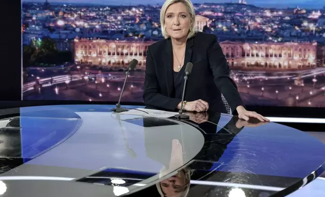 French far-right leader Marine Le Pen poses prior to an interview on French TV channel TF1, in Boulogne-Billancourt, outside Paris, Wednesday, Dec. 4, 2024 after France's far-right and left-wing lawmakers joined together to vote a no-confidence motion prompted by budget disputes that forces Prime Minister Michel Barnier to resign. (Stephane de Sakutin, Pool via AP)