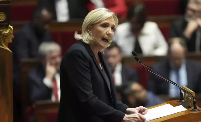 French far-right leader Marine Le Pen delivers her speech at the National Assembly prior to a no-confidence vote that could bring down the Prime Minister and the government for the first time since 1962, Wednesday, Dec. 4, 2024 in Paris. (AP Photo/Michel Euler)