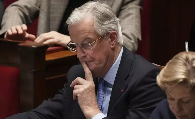 French Prime Minister Michel Barnier listens to speeches at the National Assembly prior to a no-confidence vote that could bring down the Prime Minister and the government for the first time since 1962, Wednesday, Dec. 4, 2024 in Paris. (AP Photo/Michel Euler)