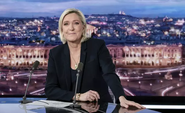 French far-right leader Marine Le Pen poses prior to an interview on French TV channel TF1, in Boulogne-Billancourt, outside Paris, Wednesday, Dec. 4, 2024 after France's far-right and left-wing lawmakers joined together to vote a no-confidence motion prompted by budget disputes that forces Prime Minister Michel Barnier to resign. (Stephane de Sakutin, Pool via AP)