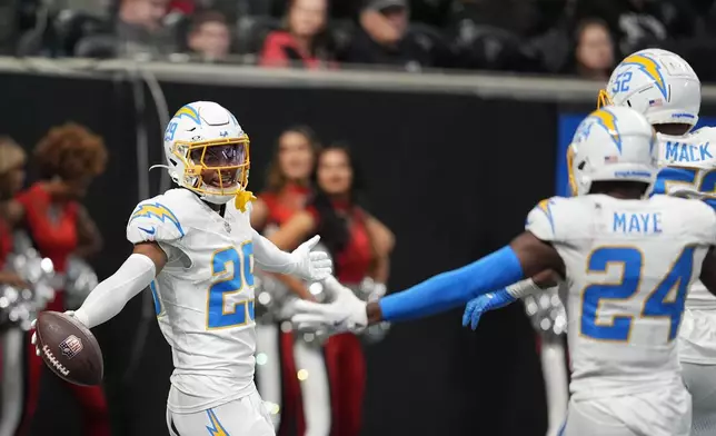 Los Angeles Chargers cornerback Tarheeb Still (29) celebrates after a pick six during the second half of an NFL football game against the Atlanta Falcons on Sunday, Dec. 1, 2024 in Atlanta. (AP Photo/Mike Stewart)