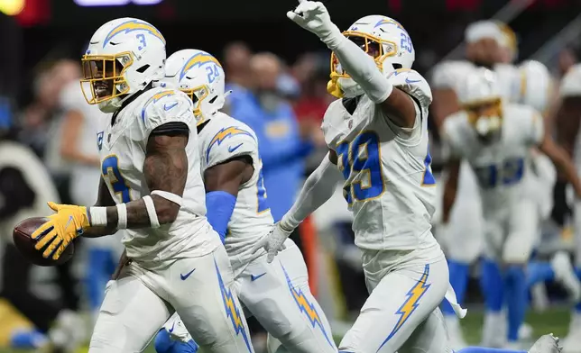 Los Angeles Chargers safety Derwin James Jr. (3) celebrates after an interception during the second half of an NFL football game against the Atlanta Falcons on Sunday, Dec. 1, 2024 in Atlanta. (AP Photo/Mike Stewart)