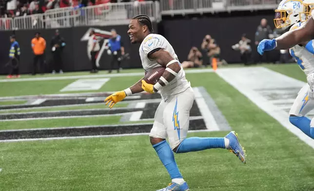 Los Angeles Chargers safety Derwin James Jr. (3) celebrates after an interception during the second half of an NFL football game against the Atlanta Falcons on Sunday, Dec. 1, 2024 in Atlanta. (AP Photo/John Bazemore)