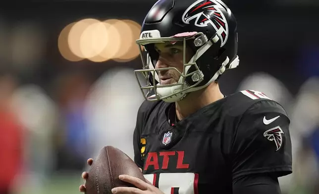 Atlanta Falcons quarterback Kirk Cousins (18) warms up before an NFL football game against the Los Angeles Chargers on Sunday, Dec. 1, 2024 in Atlanta. (AP Photo/Mike Stewart)