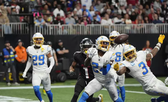 Los Angeles Chargers safety Marcus Maye (24) intercepts the ball thrown by Atlanta Falcons quarterback Kirk Cousins (18) during the second half of an NFL football game on Sunday, Dec. 1, 2024 in Atlanta. (AP Photo/Mike Stewart)