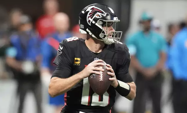 Atlanta Falcons quarterback Kirk Cousins (18) looks to pass during the first half of an NFL football game against the Los Angeles Chargers on Sunday, Dec. 1, 2024 in Atlanta.(AP Photo/Mike Stewart)