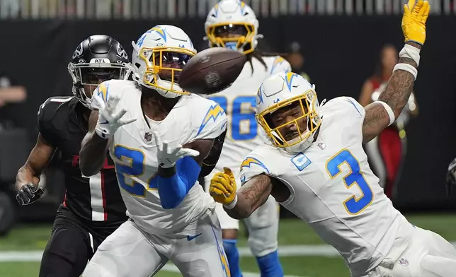 Los Angeles Chargers safety Marcus Maye (24) intercepts the ball thrown by Atlanta Falcons quarterback Kirk Cousins (18) during the second half of an NFL football game on Sunday, Dec. 1, 2024 in Atlanta. (AP Photo/Mike Stewart)