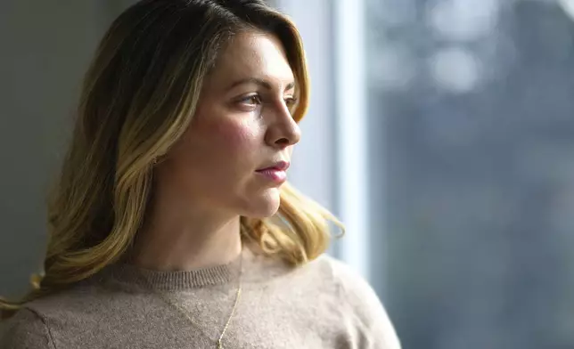 FILE - Grace Boutot, who won a silver medal at the 2009 Youth World Championships, stands for a photograph in her home, Sunday, Dec. 8, 2024, in Boston. (AP Photo/Steven Senne, File)
