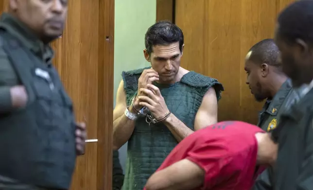 Alon Alexander, 37, top, and his twin brother, Oren, bottom, prepare to be escorted out of court after being charged with multiple state and federal crimes, including sex trafficking and rape, at the Richard E. Gerstein Justice Building on Friday, Dec. 13, 2024, in Miami. (Matias J. Ocner/Miami Herald via AP, Pool)