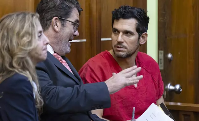 Oren Alexander, 37, right, talks to his attorneys Joel Denaro and Michelle Roth after bond hearing after he and his twin brother Alon Alexander, were charged with multiple state and federal crimes, including sex trafficking and rape, at the Richard E. Gerstein Justice Building on Friday, Dec. 13, 2024, in Miami. (Matias J. Ocner/Miami Herald via AP, Pool)