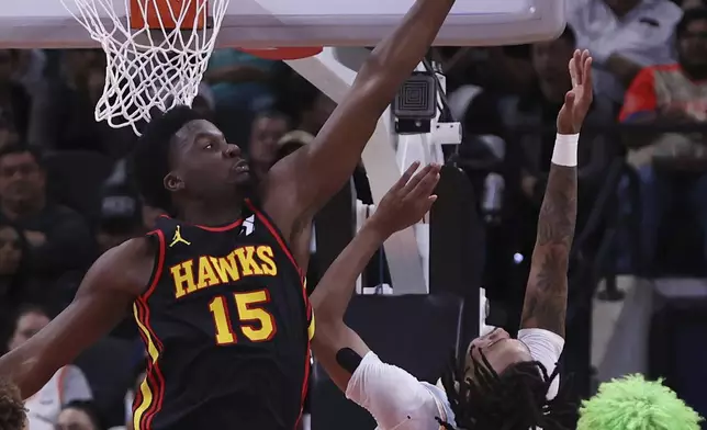 Atlanta Hawks center Clint Capela (15) blocks a shot by San Antonio Spurs guard Stephon Castle (5) during the first half of an NBA basketball game in San Antonio, Thursday, Dec. 19, 2024. (AP Photo/Kin Man Hui)